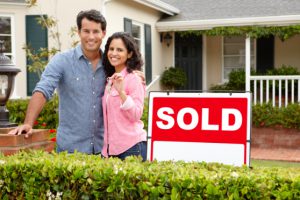 conveyancing buying a new home couple with keys to new home